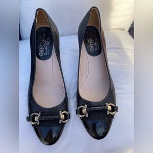 Timeless classic Ferragamo Black leather pumps gold Tone buckle on patent toe.